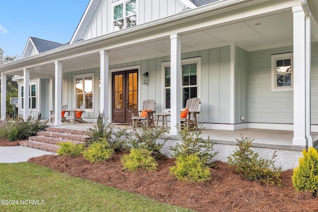 view of exterior entry with a porch