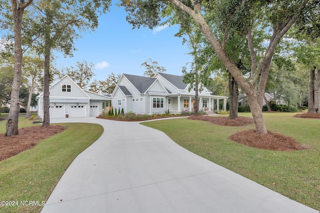 view of front of house with a porch, a front lawn, and a garage