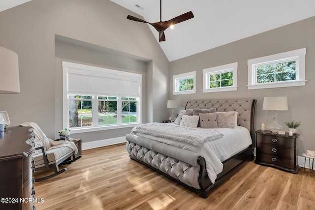 bedroom with light hardwood / wood-style flooring, high vaulted ceiling, and ceiling fan