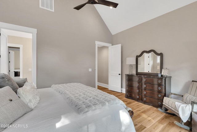 bedroom with light hardwood / wood-style flooring, high vaulted ceiling, and ceiling fan