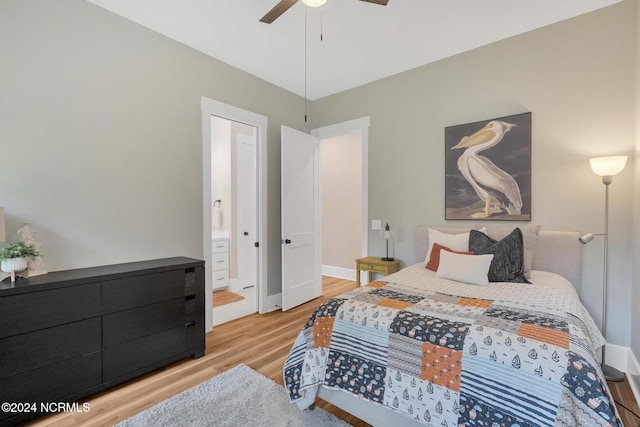 bedroom featuring ensuite bath, light wood-type flooring, and ceiling fan