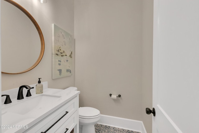 bathroom featuring vanity, toilet, and tile patterned floors