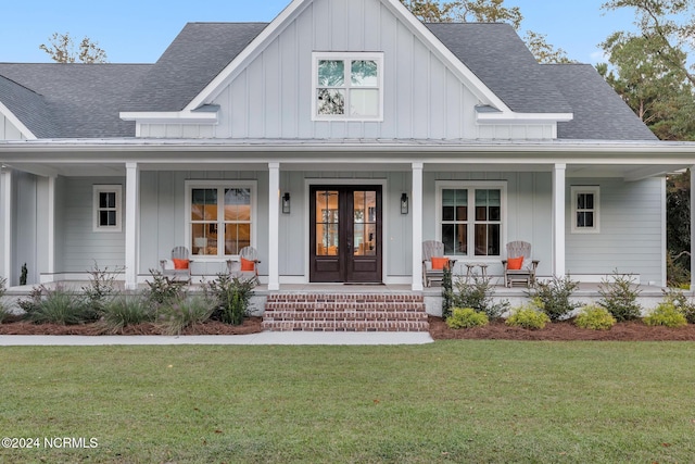 view of front of home with covered porch and a front yard