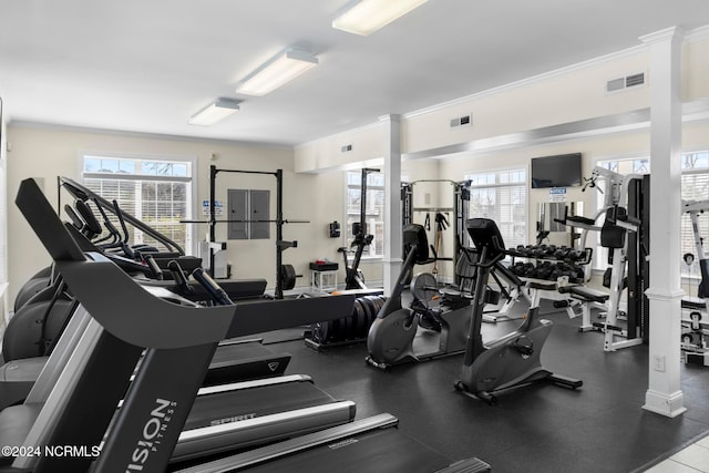 workout area featuring crown molding