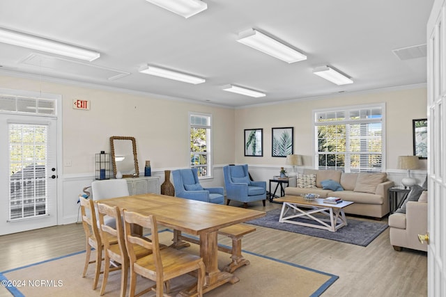 interior space featuring ornamental molding, light wood-type flooring, and a wealth of natural light