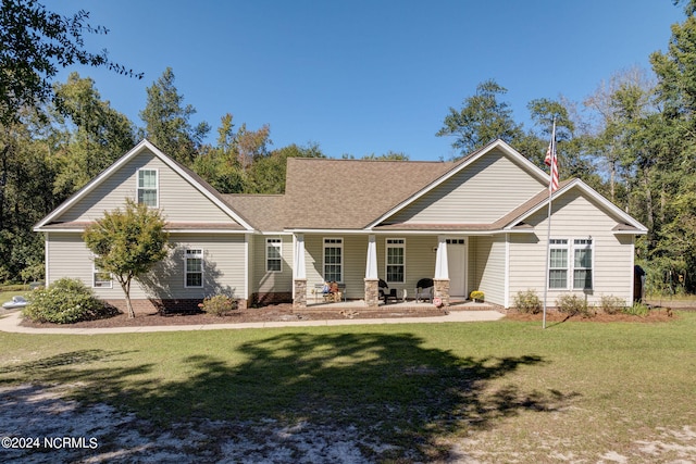 exterior space featuring covered porch and a lawn