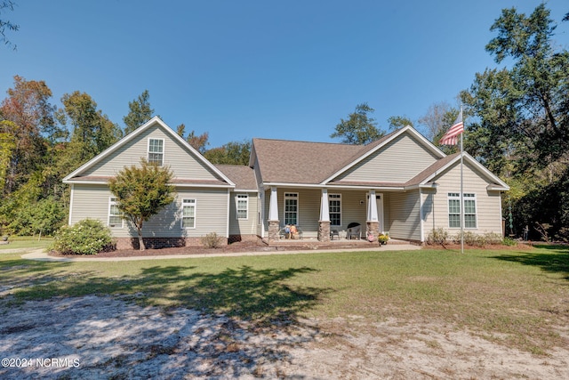 view of front of house featuring covered porch and a front lawn