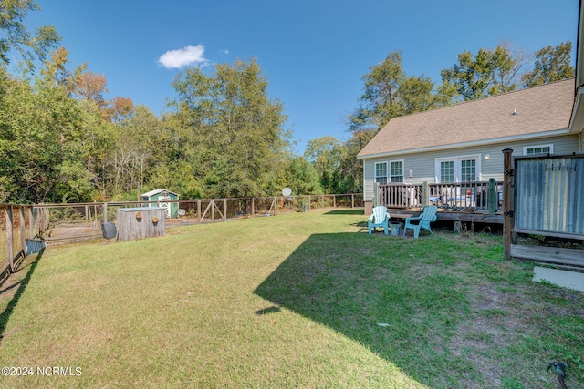 view of yard featuring a shed and a deck