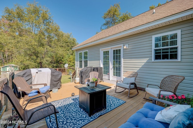 wooden deck featuring grilling area and an outdoor hangout area