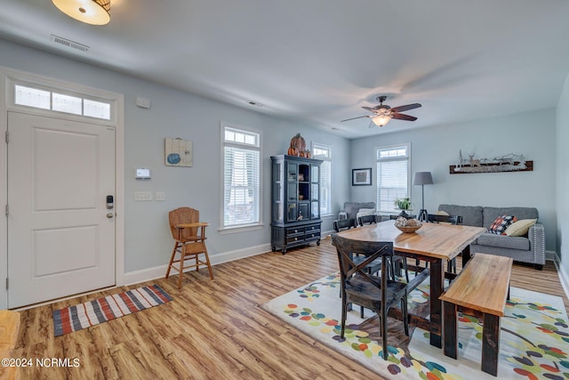 dining area featuring light hardwood / wood-style flooring, a healthy amount of sunlight, and ceiling fan