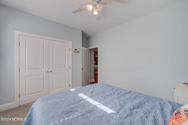 carpeted bedroom featuring a closet and ceiling fan