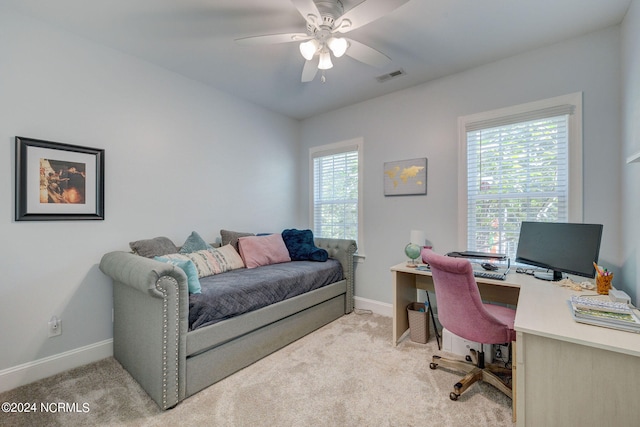 carpeted bedroom featuring multiple windows and ceiling fan