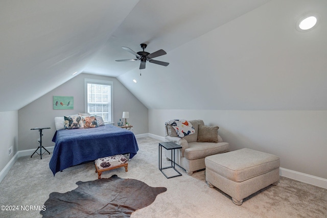 bedroom with ceiling fan, vaulted ceiling, and light colored carpet