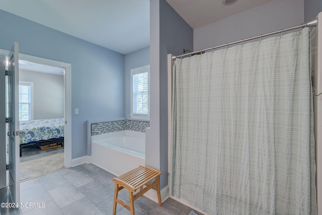 bathroom featuring tile patterned floors and independent shower and bath