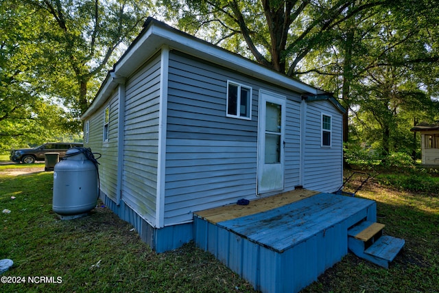 view of outbuilding featuring a lawn