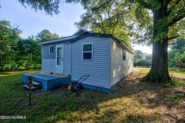 rear view of property with a yard