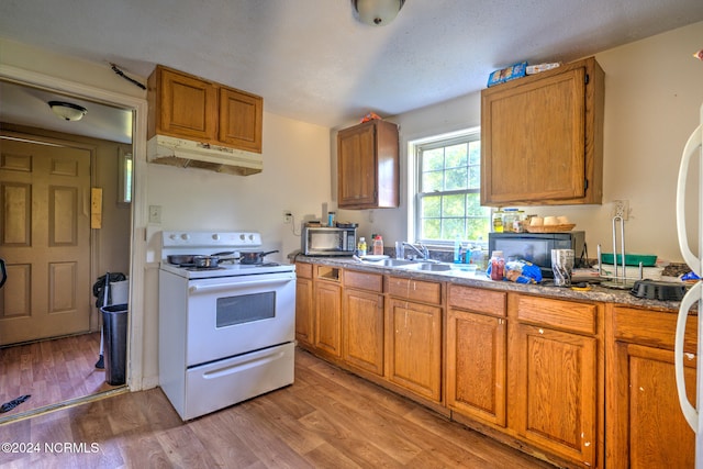 kitchen featuring light hardwood / wood-style flooring, white range with electric stovetop, a textured ceiling, and sink