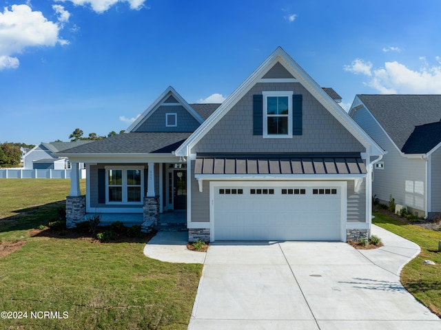 craftsman-style home with a front yard and a garage