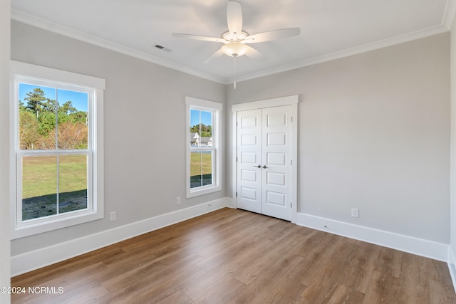 unfurnished bedroom with light hardwood / wood-style floors, multiple windows, and ceiling fan