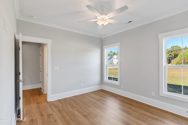 spare room featuring light hardwood / wood-style floors, crown molding, plenty of natural light, and ceiling fan