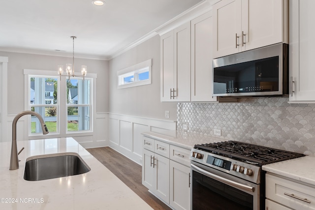 kitchen featuring a healthy amount of sunlight, stainless steel appliances, and light stone counters