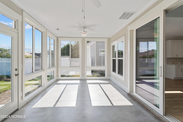 unfurnished sunroom featuring ceiling fan