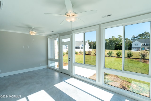 unfurnished sunroom with ceiling fan and a wealth of natural light