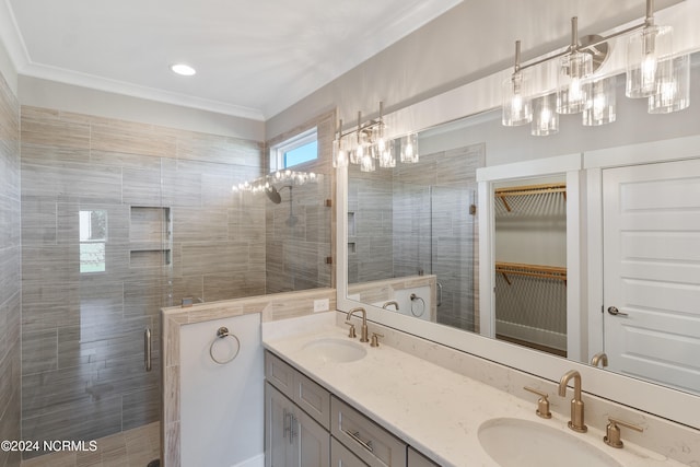 bathroom featuring vanity, crown molding, and walk in shower