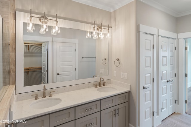 bathroom featuring vanity, a notable chandelier, and ornamental molding