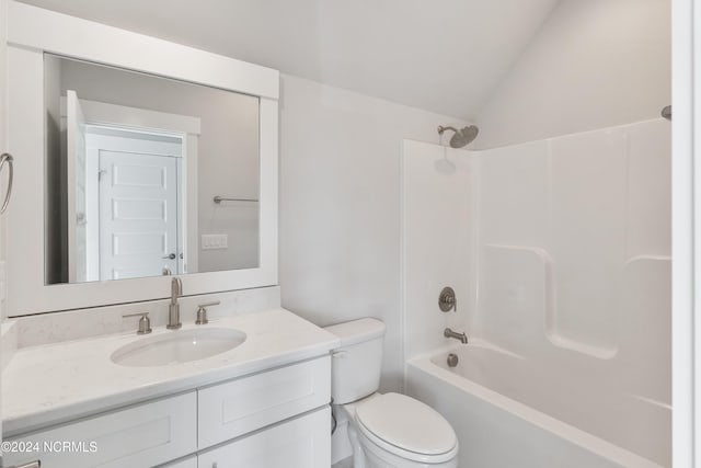 full bathroom featuring vanity, toilet, vaulted ceiling, and shower / tub combination