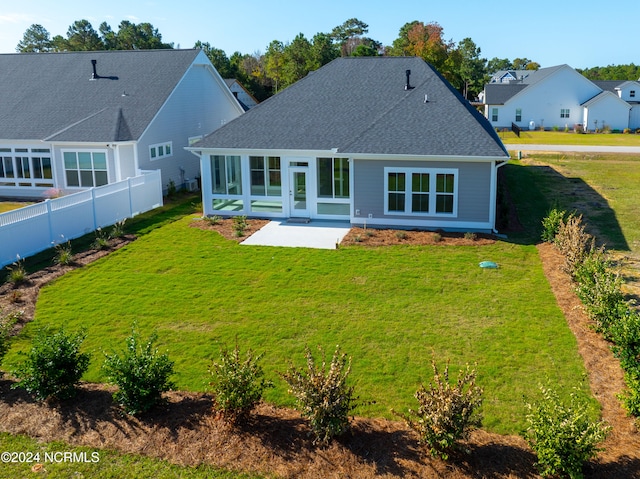 rear view of house with a yard and a patio area