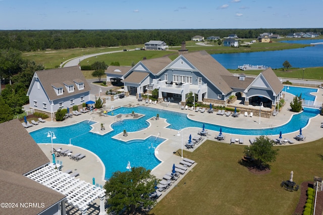 view of swimming pool with a patio and a water view