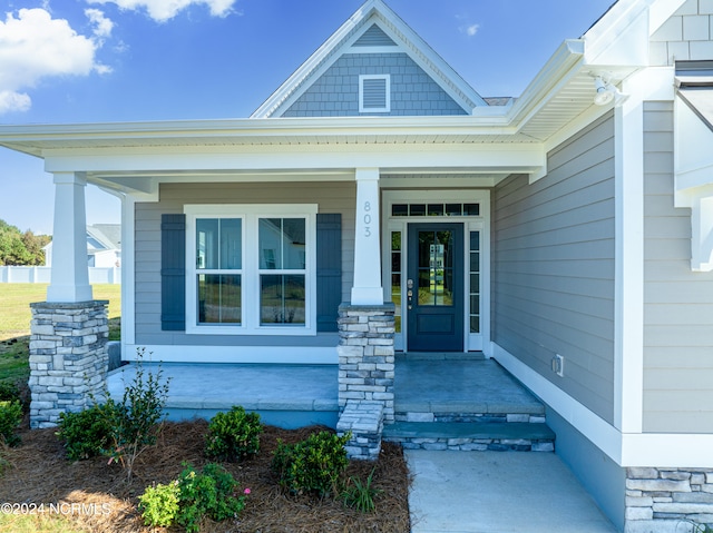 property entrance with covered porch