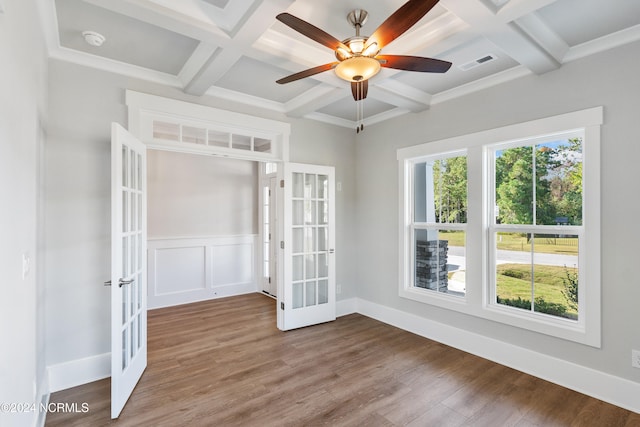 spare room with beam ceiling, ceiling fan, hardwood / wood-style flooring, french doors, and coffered ceiling