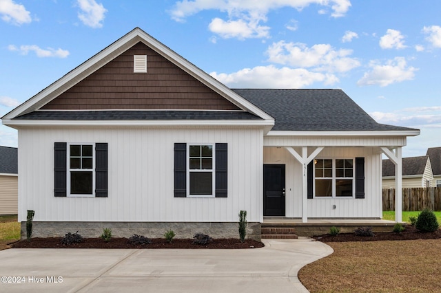 view of front of house with covered porch and a front yard