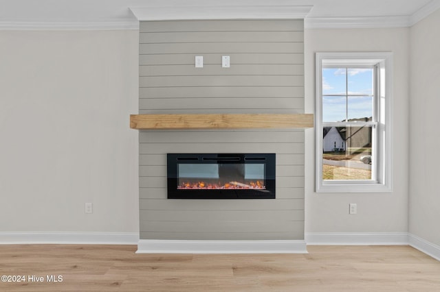 interior details with a fireplace, hardwood / wood-style flooring, and crown molding