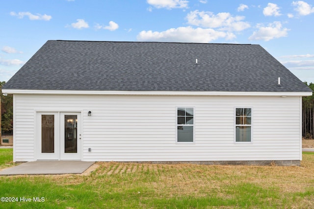 rear view of property with a patio and a lawn