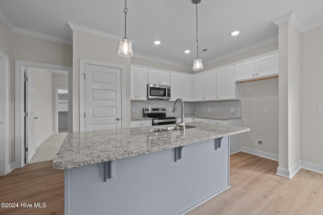 kitchen with a breakfast bar, white cabinetry, stainless steel appliances, and decorative light fixtures