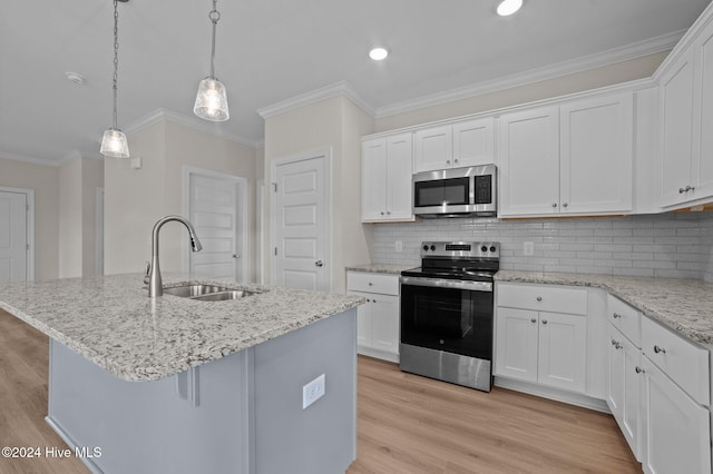 kitchen with backsplash, white cabinetry, sink, and stainless steel appliances