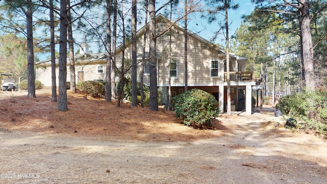 view of side of home featuring a wooden deck