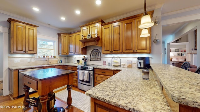 kitchen with appliances with stainless steel finishes, decorative light fixtures, sink, a breakfast bar area, and light stone counters