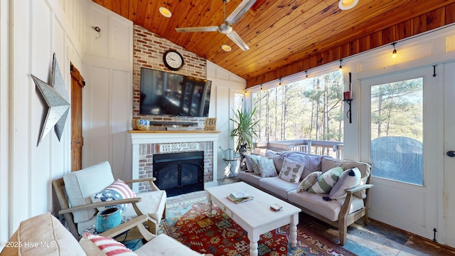 sunroom / solarium featuring a fireplace, vaulted ceiling, and wooden ceiling