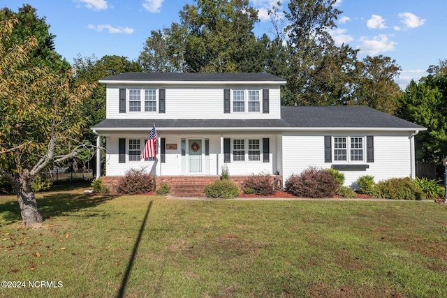 front facade with a porch and a front yard