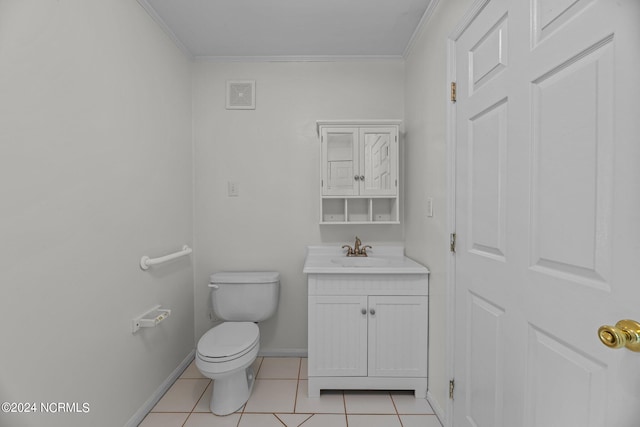 bathroom with toilet, ornamental molding, vanity, and tile patterned flooring