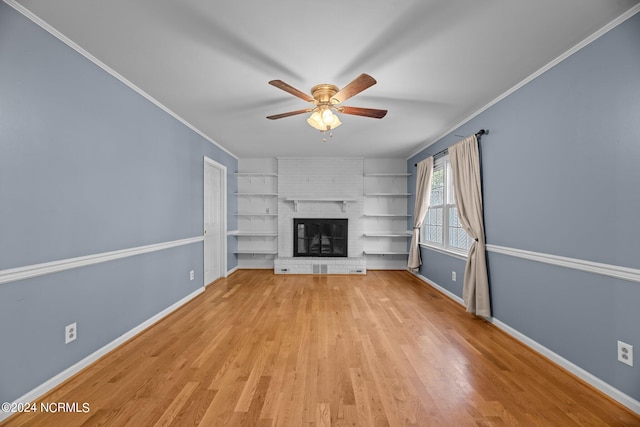 unfurnished living room with crown molding, a fireplace, and light hardwood / wood-style floors