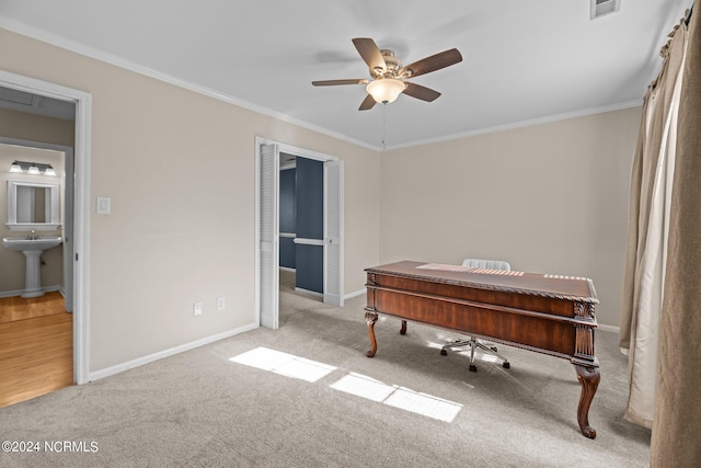 miscellaneous room featuring ceiling fan, light carpet, ornamental molding, and sink