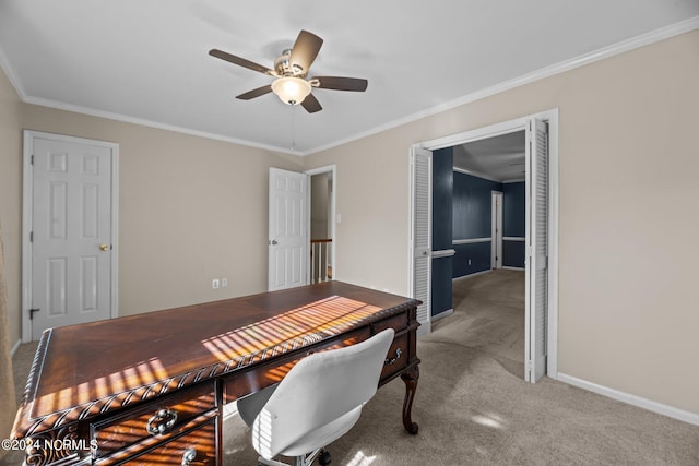 carpeted office space with ceiling fan and ornamental molding