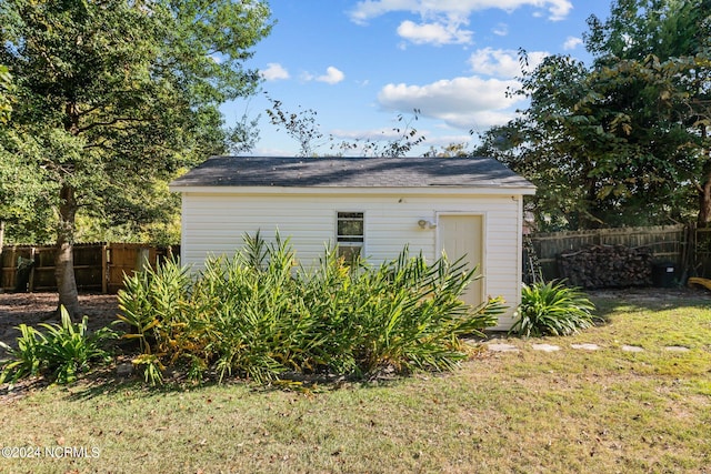 view of outbuilding with a yard