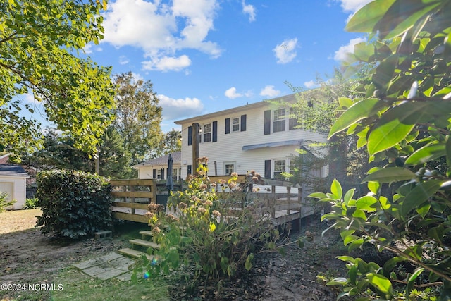 back of house featuring a deck