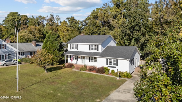 view of front of property with a front yard and covered porch